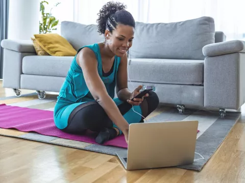 A woman preparing to exercise in her living room.