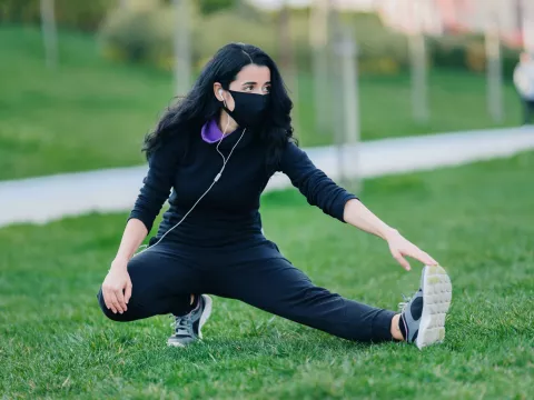 A woman stretching before she exercises