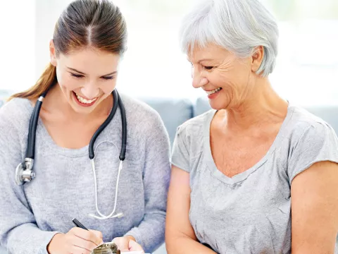 A woman goes over her lab results with her doctor.