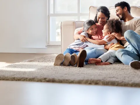 a family sitting on a rug