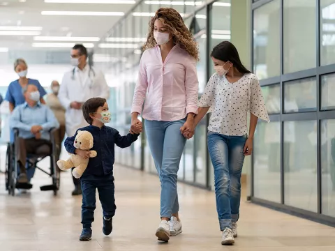 Mother, son and daughter leaving the emergency room.