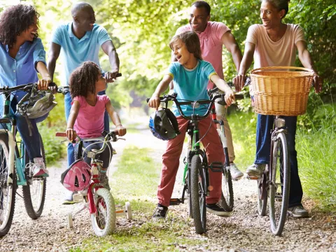 Multigenerational family riding bikes together.