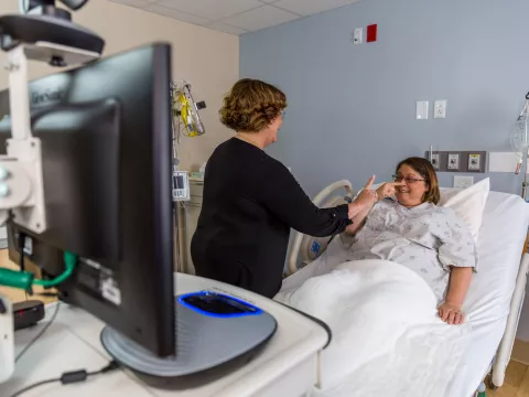 Physician helping a female patient