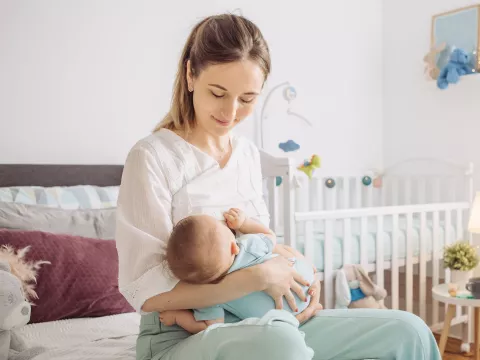 A woman breastfeeding her infant. 