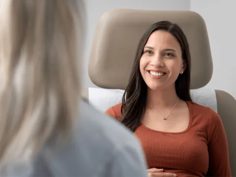 A female patient smiling at her healthcare provider.