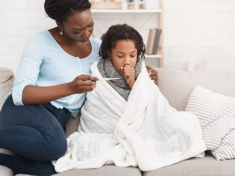 A mother taking her sick child's temperature