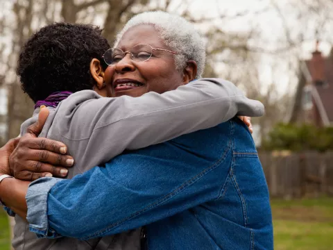 Woman Hugging Family Member