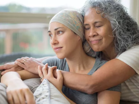 A senior mother hugging her mature daughter