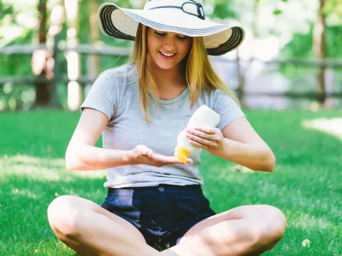 Woman Applying Sunscreen