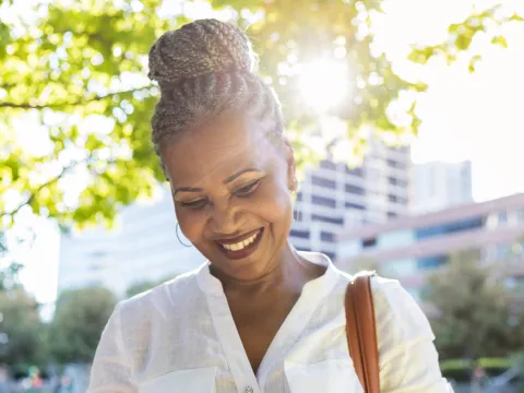 Woman using her phone while at a park.