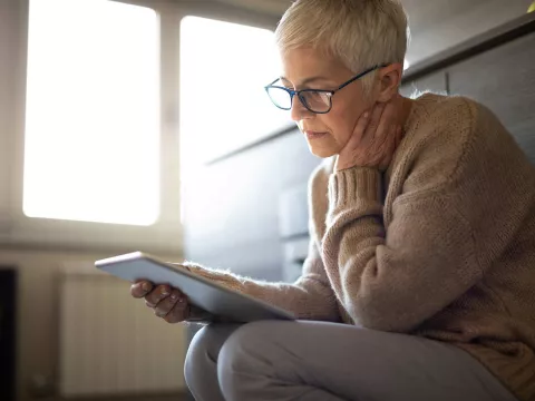 A senior woman on her tablet device