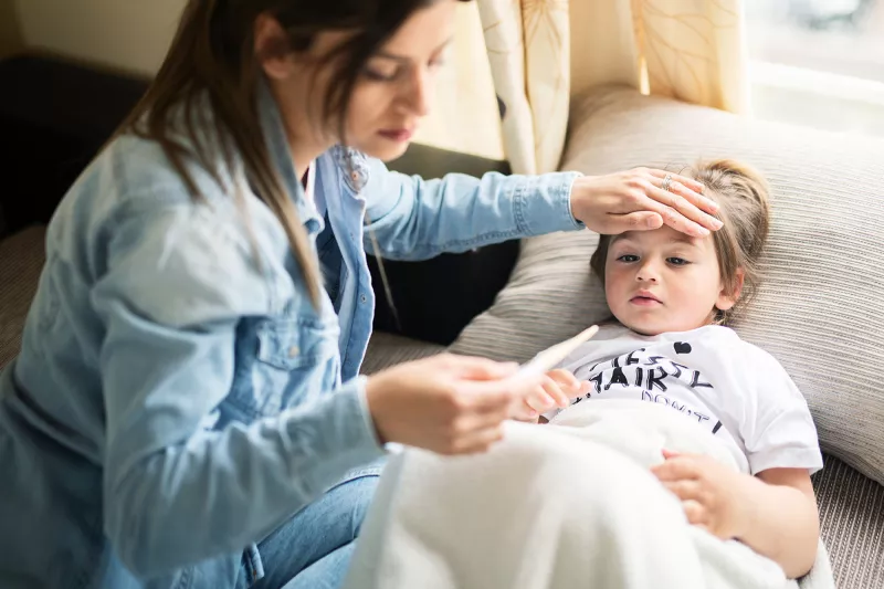 A mother checking her child's fever