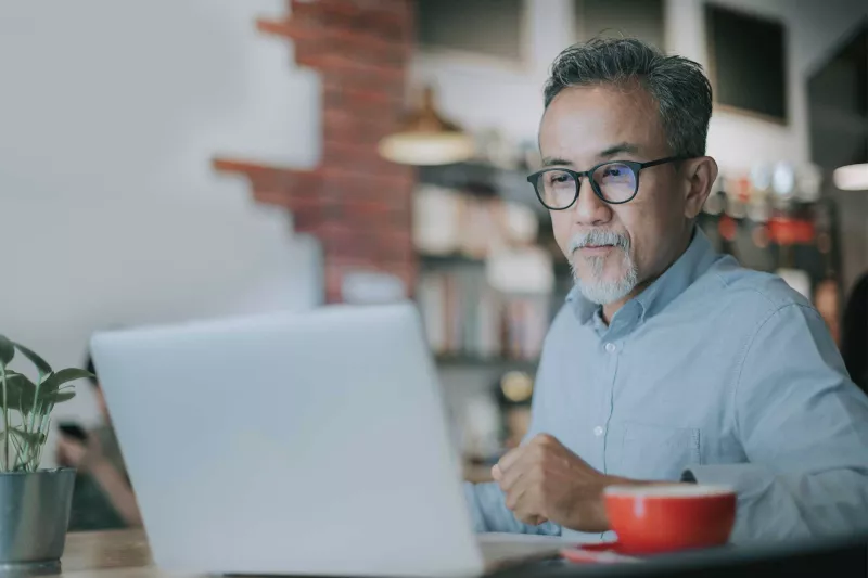 An mature man on his laptop