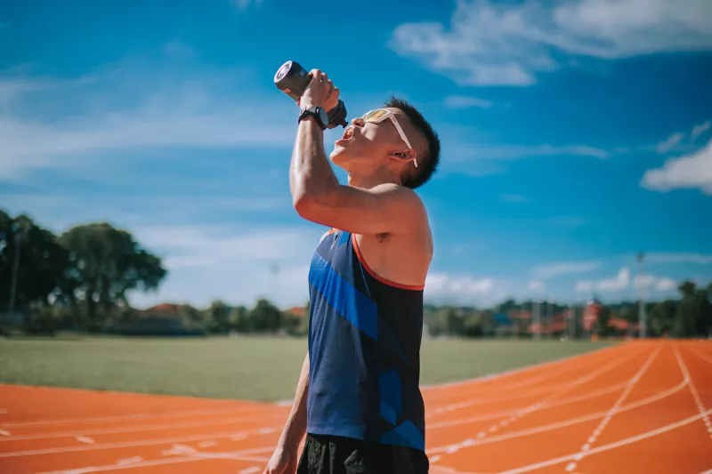 A young, asian adult on a water break