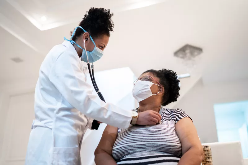 Female patient with female doctor with PPE