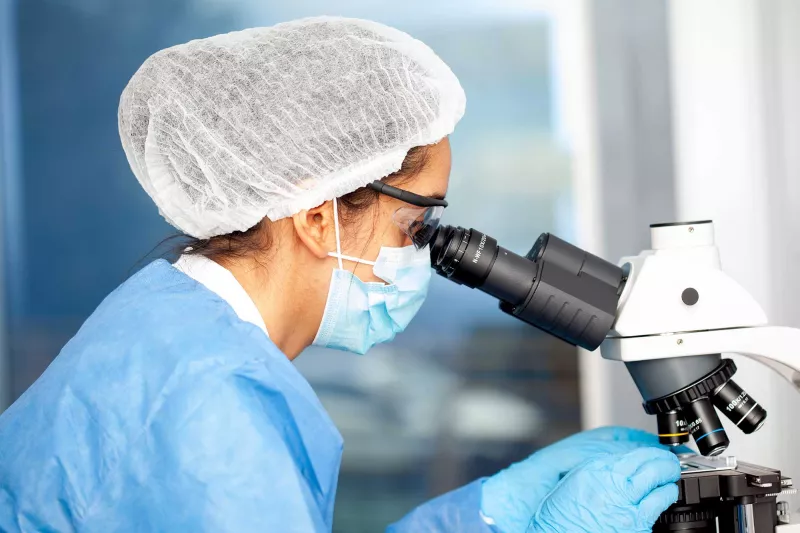 A histopathologist using a microscope