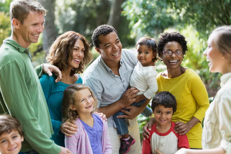 A Blended Family Walks Through a Park with a Guide.