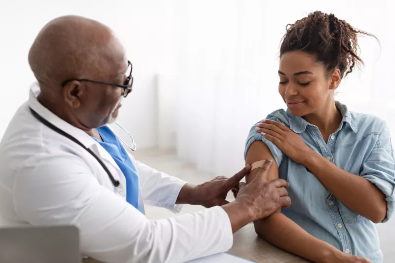 A Doctor Put on a Bandage After Giving an Injection