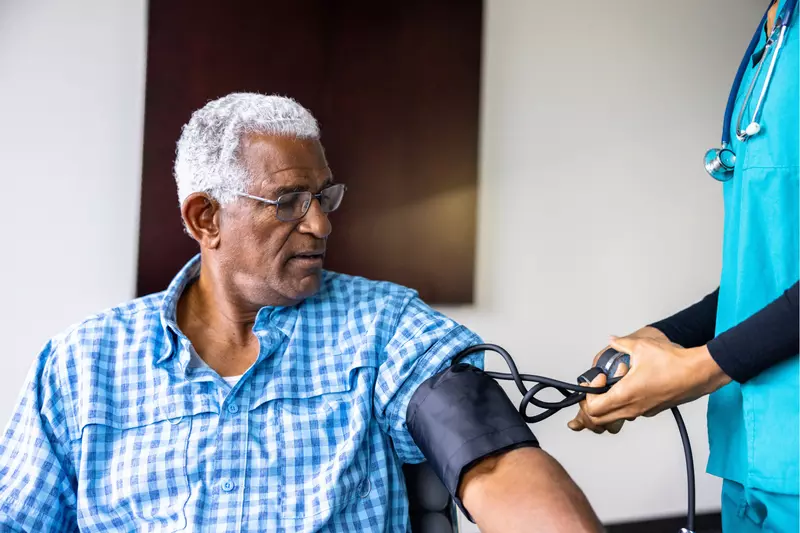 A Patient Has His Blood Pressure Taken By a Nurse in a Practice.