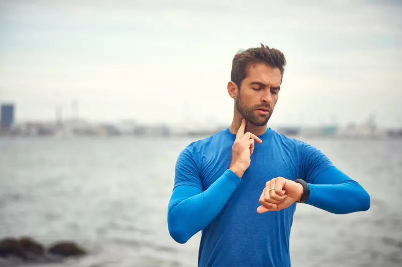 A Man Takes a Break From His Jog to Check His Pulse.