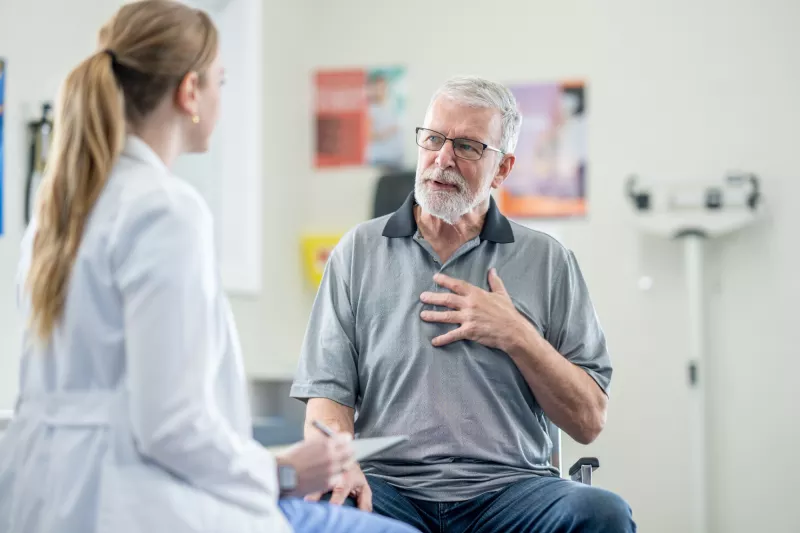 A Senior Patient Speaks to His Physician is an Exam Room