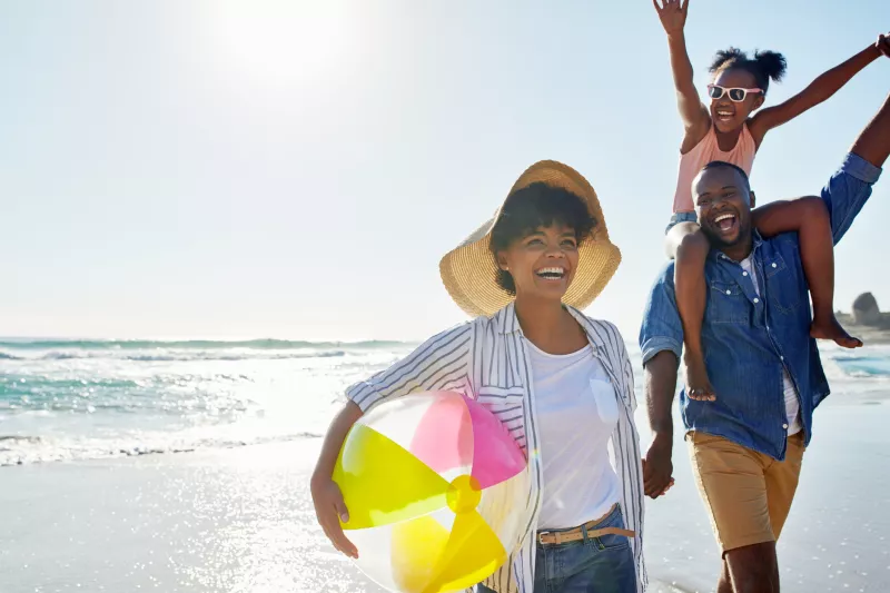 A healthy family enjoys a summer day on the beach.