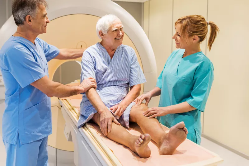 Friendly staff help a man prepare for an imaging test.
