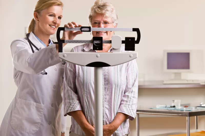 Woman on a scale at a doctor's office