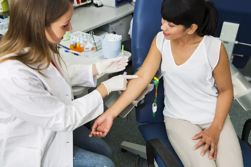 Woman prepares to have her blood drawn