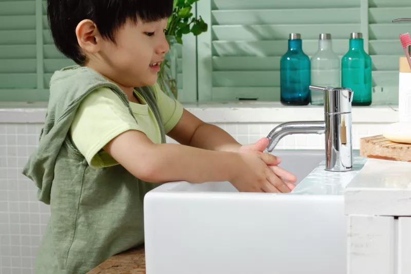 Little boy washing his hands