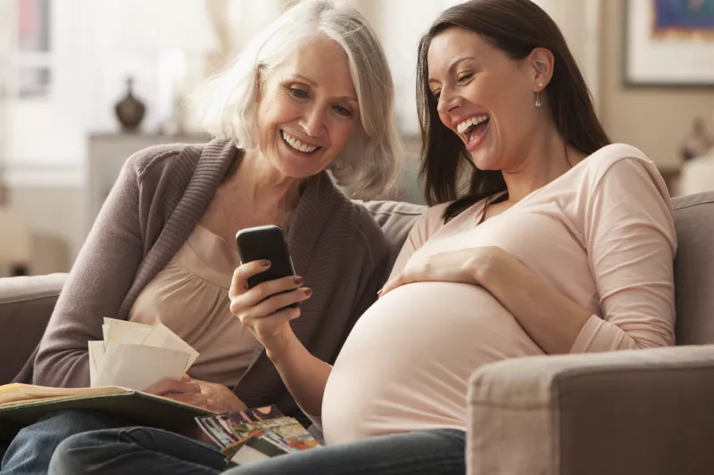 Pregnant woman looking at photos