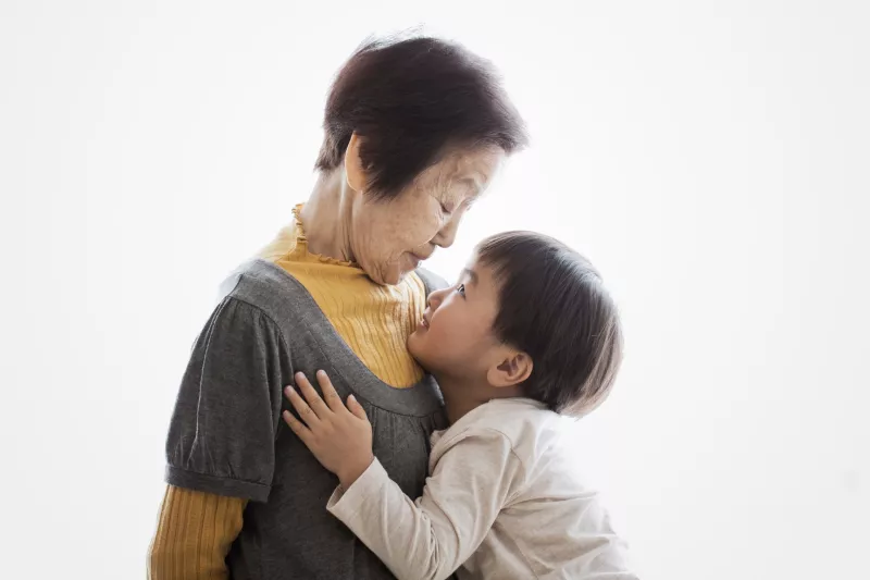 A grandmother shares a moment with her grandson.