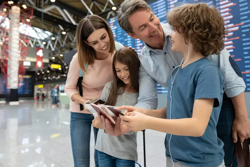 A family double checks their passports before an international flight.