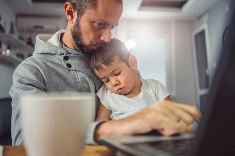 Father and son on the computer together.