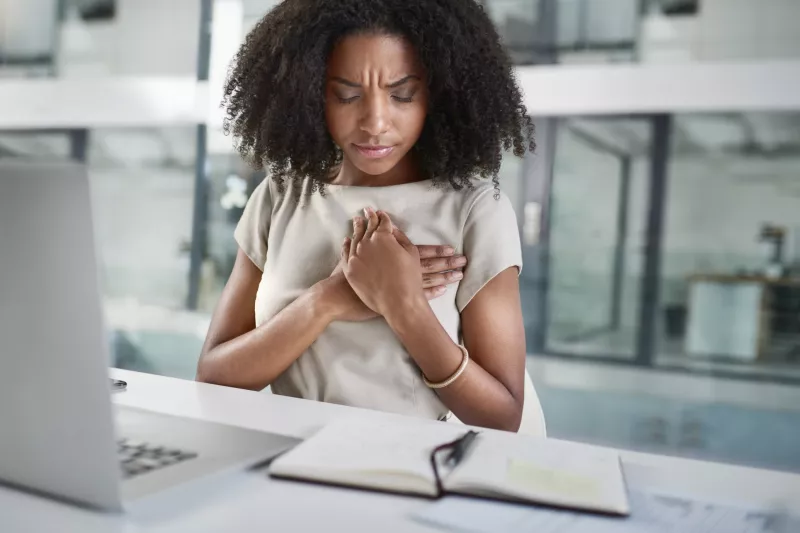 A young woman experiencing chest pain.