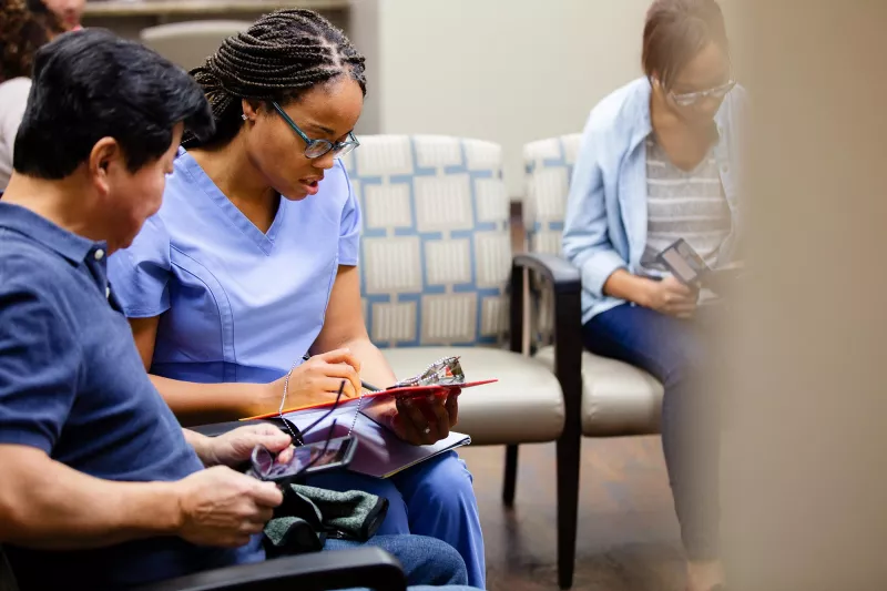 Man talking to nurse in ER