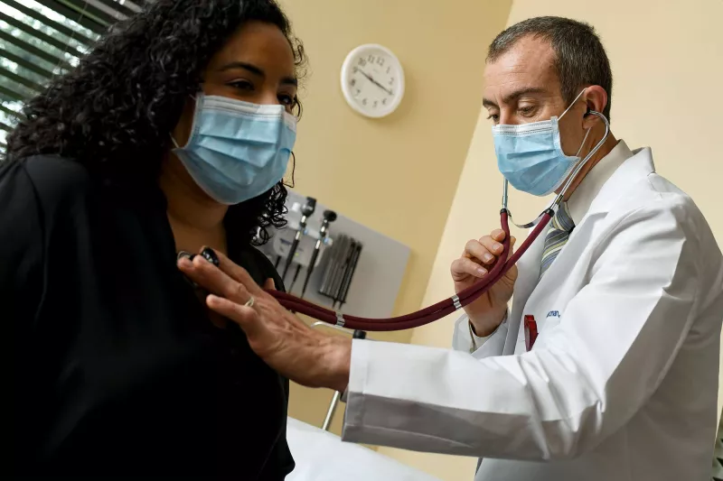 A doctor checking up on a patient.