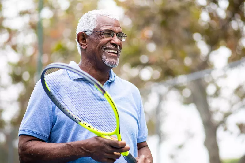 Man holding a tennis raquet  