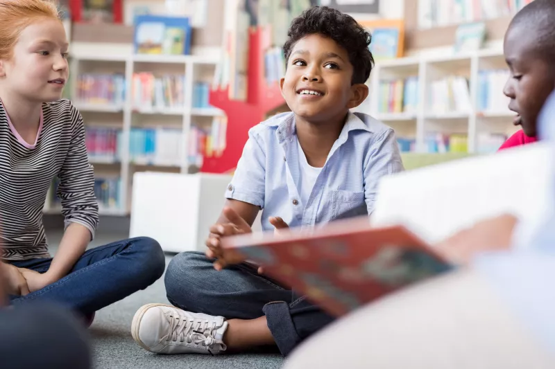 A child enjoying a story in the classroom.