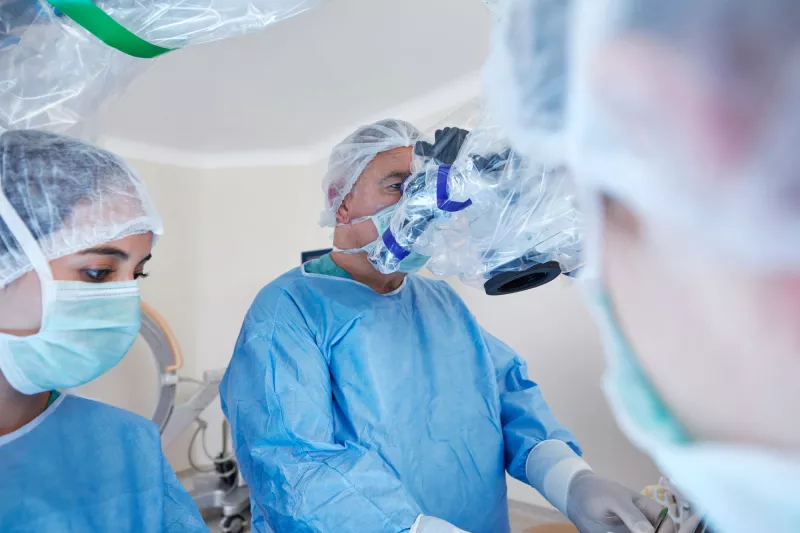 A doctor using a machine to assist in surgery