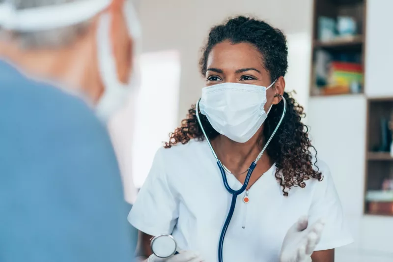 A doctor talking to a patient during an office visit.