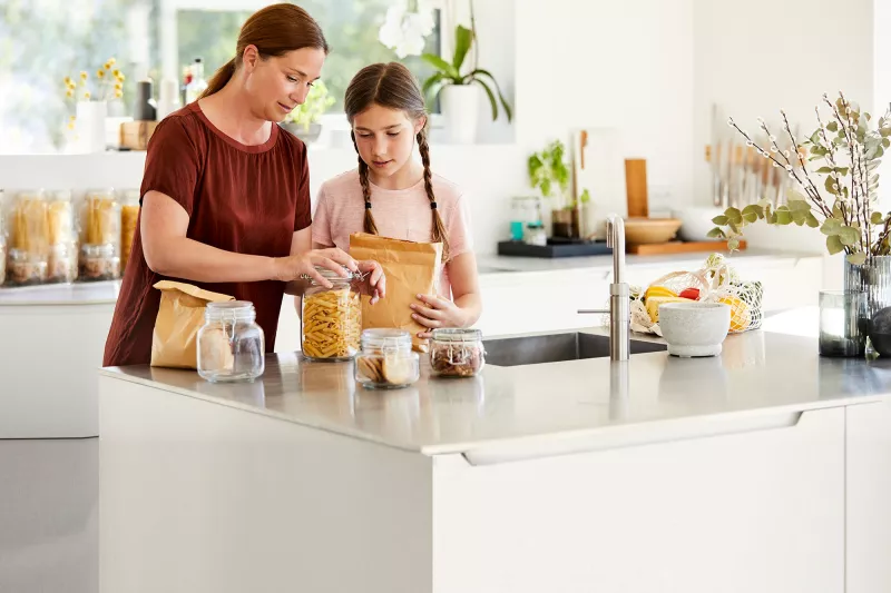 Mother and daughter preparing food.