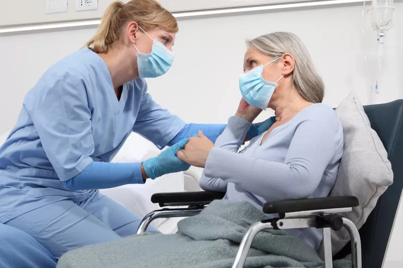 A caregiver comforts a patient.