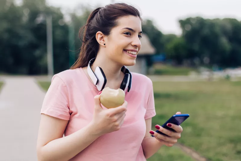 A woman eating an apple.