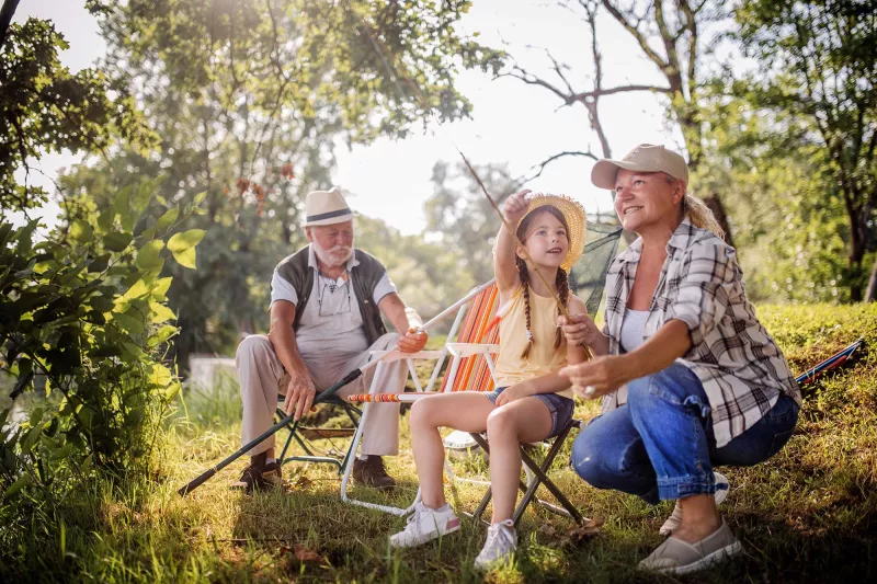 Grandparents getting ready to fish with their granddaughter