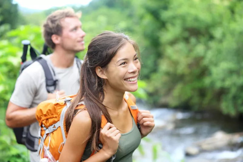 A happy couple hiking.