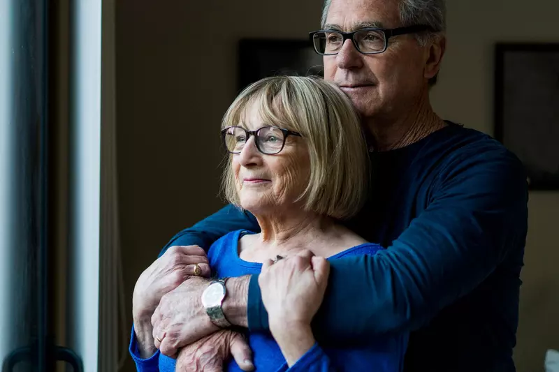 Elderly white couple embracing 