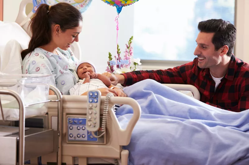A joyful family welcomes a new baby.