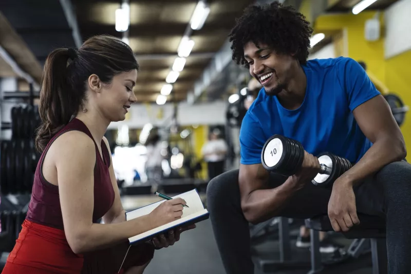 A man exercising with a personal trainer.