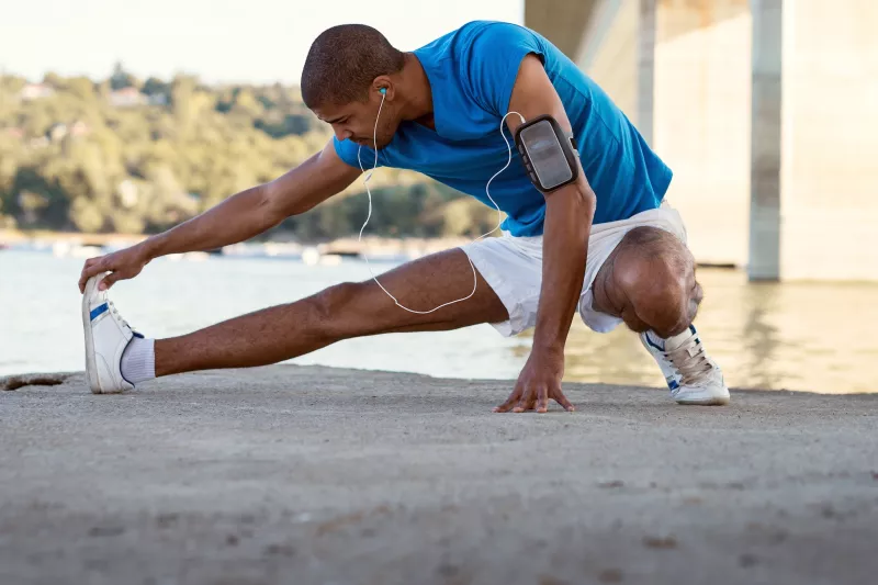 A man stretching after a run.